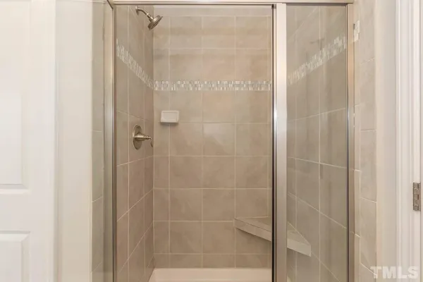a bathroom with a glass shower door