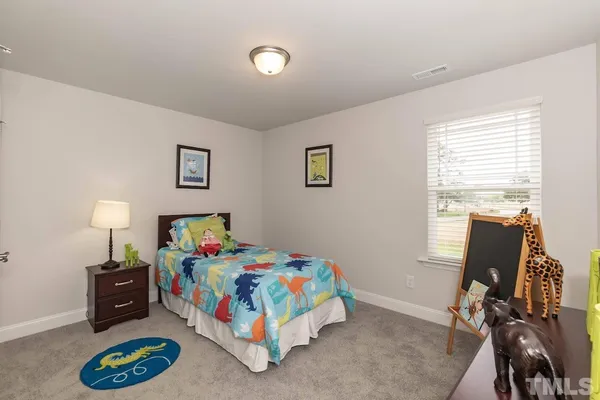 a bedroom with a bed and a desk