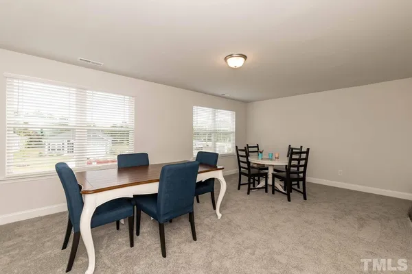 a view of a workspace with furniture and a window in the room