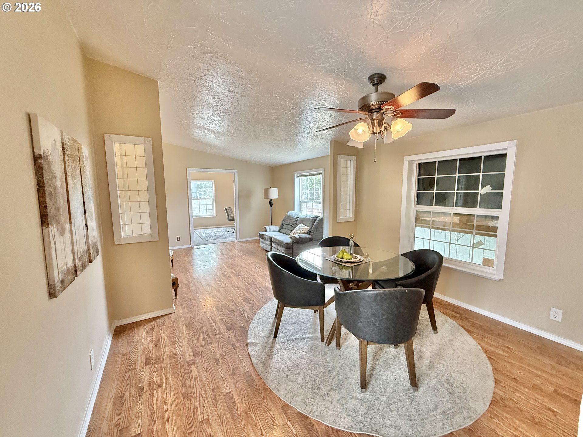 1282 3rd Street, Unit 37 Lafayette, OR 97127 - Photo 14 of 28 a dining room with furniture a chandelier and wooden floor