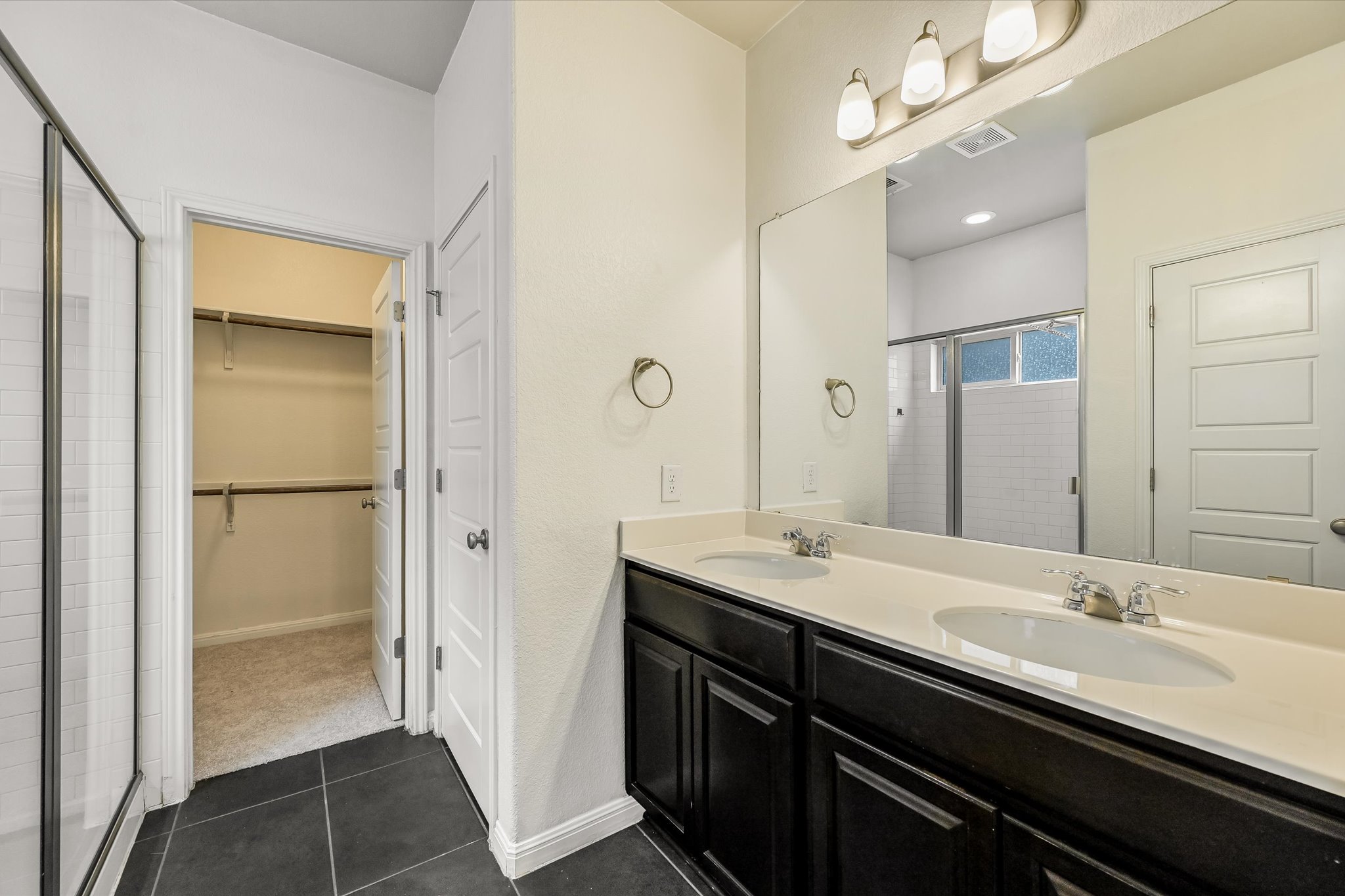 7709 Menchaca Road, Unit 1 Austin, TX 78745 - Photo 16 of 29 Primary bathroom features large walk-in shower, walk-in closet and dual sink vanity.