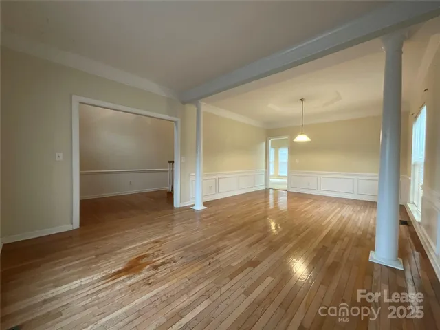 a view of a room with wooden floor
