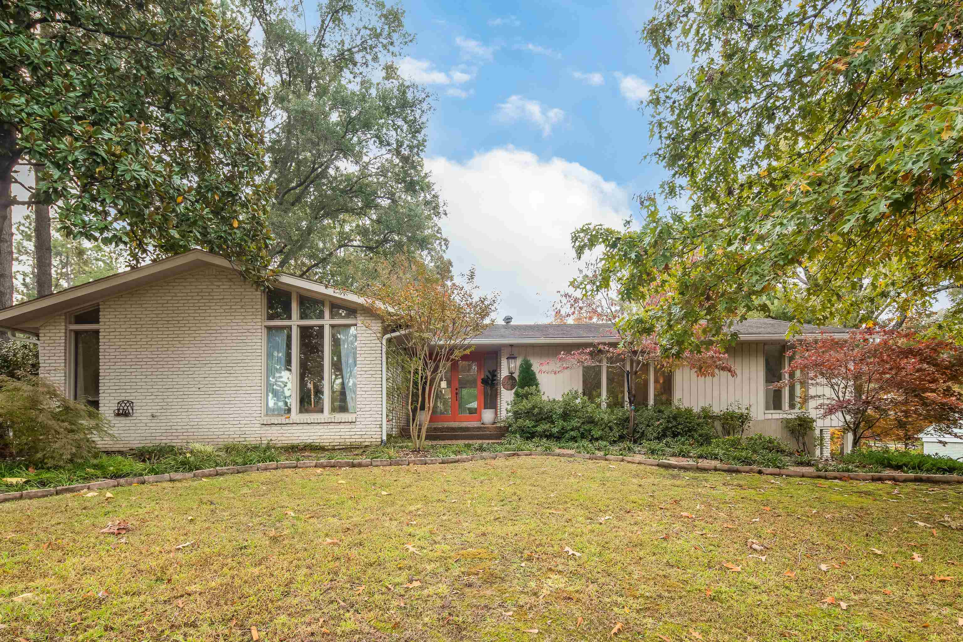 5585 Walnut Grove Road Memphis, TN 38120 - Photo 1 of 25 a front view of house with yard and trees around