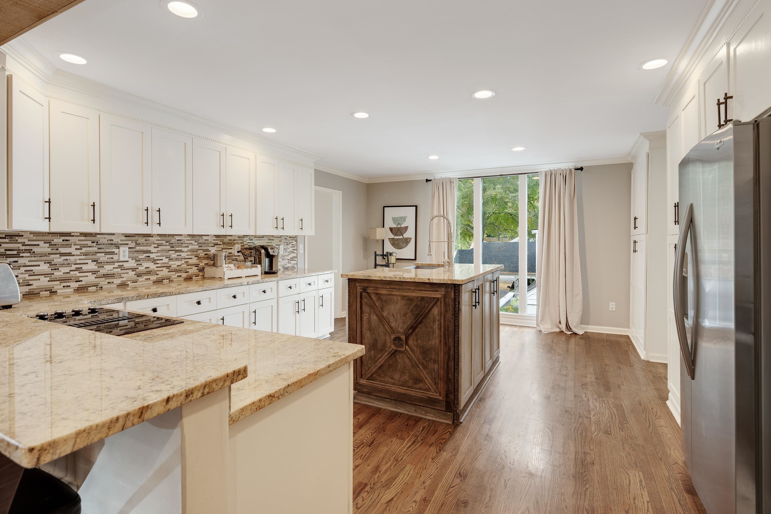5585 Walnut Grove Road Memphis, TN 38120 - Photo 11 of 25 a kitchen with a refrigerator a stove a sink and a microwave