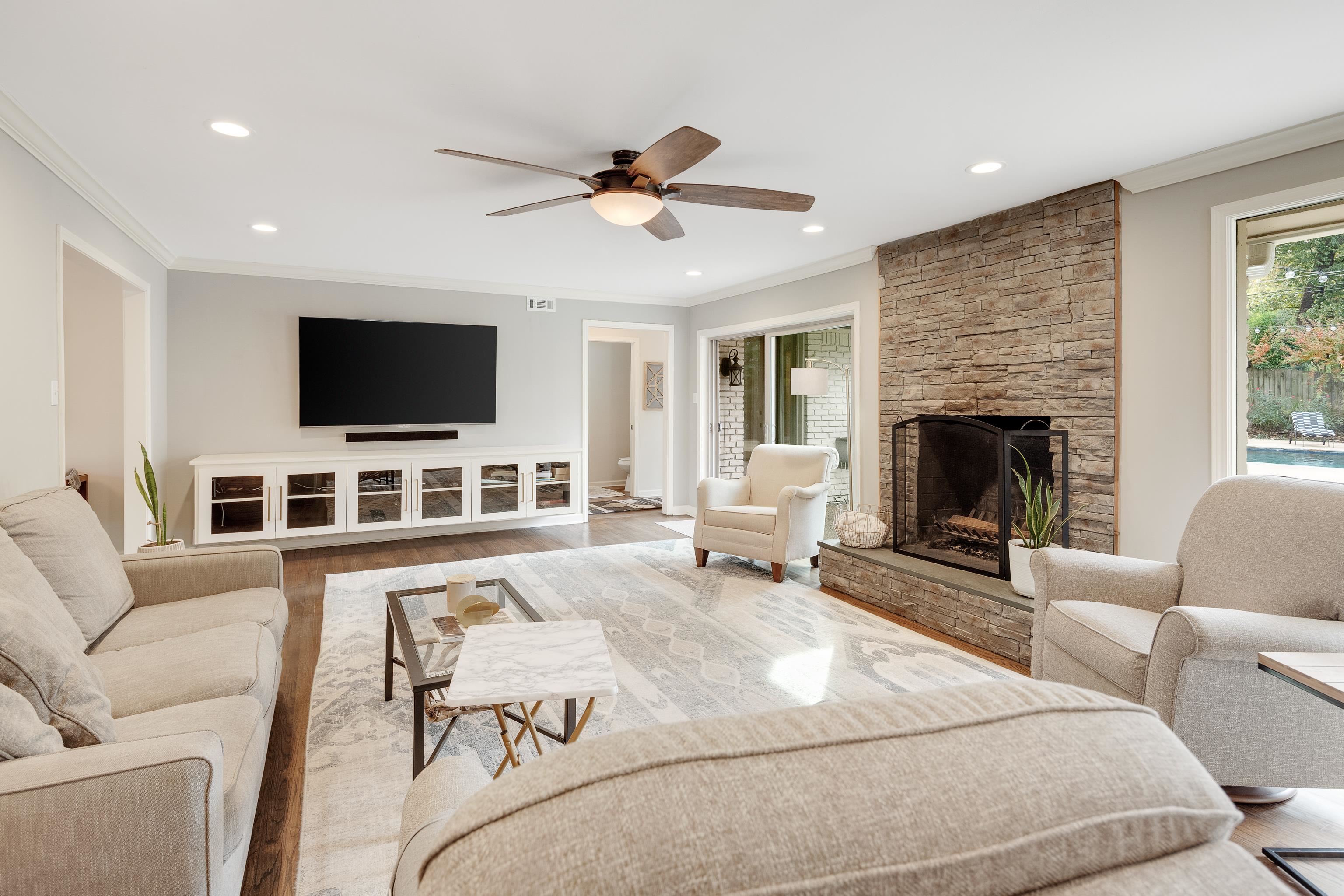 5585 Walnut Grove Road Memphis, TN 38120 - Photo 9 of 25 a living room with furniture and a flat screen tv