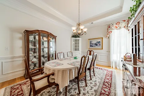 a view of a dining room with furniture and chandelier
