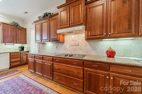 a kitchen with granite countertop cabinets and window