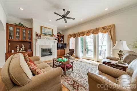 a living room with furniture ceiling fan and a fireplace
