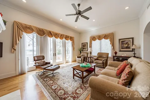 a living room with furniture ceiling fan and a window
