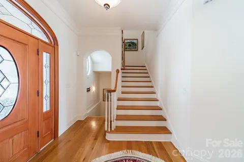 a view of entryway and hall with wooden floor
