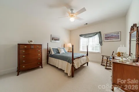 a bedroom with furniture and a ceiling fan