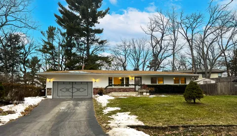 a view of house with a garden in the background