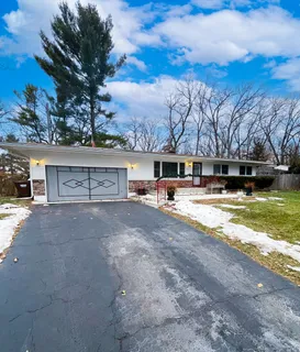 a view of house with outdoor space and swimming pool