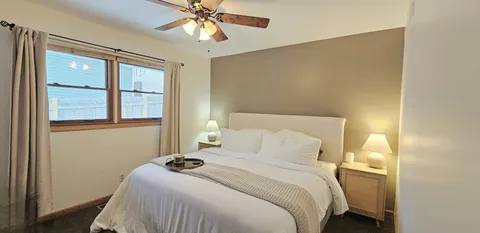 a bedroom with a bed and a chandelier