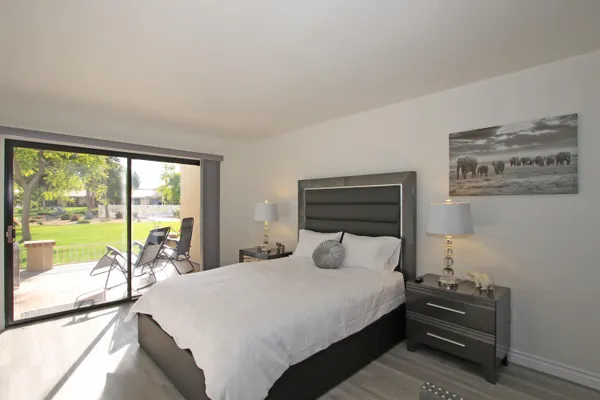 a bedroom with a bed and a large window