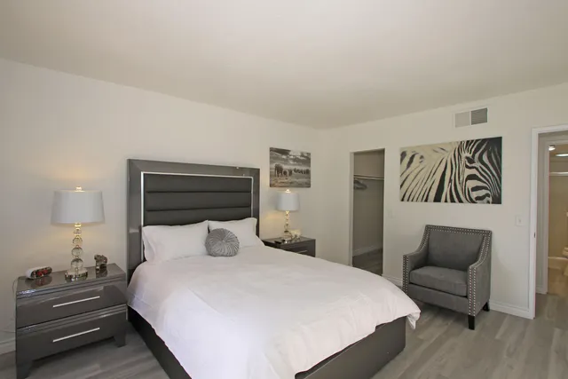 a bedroom with a bed and a couch