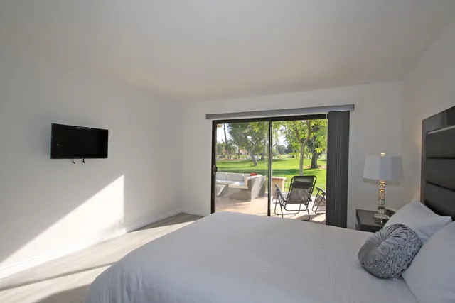 a bed room with a bed and a television