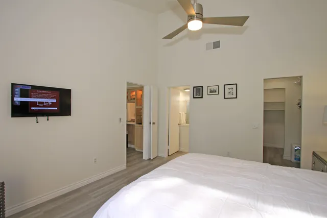 a bedroom with a bed and a chandelier