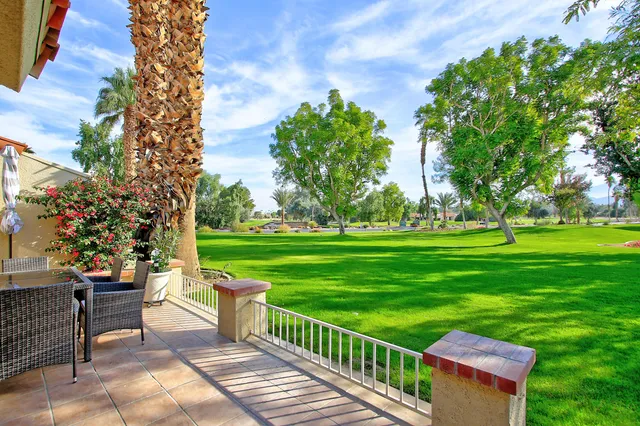 a view of a garden with an outdoor seating