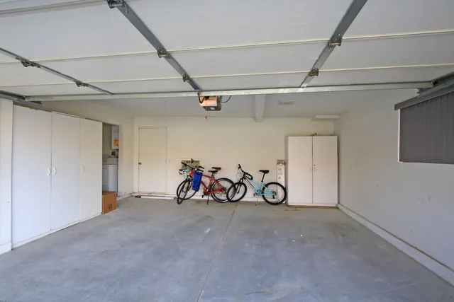 a view of a garage with a bike and white walls