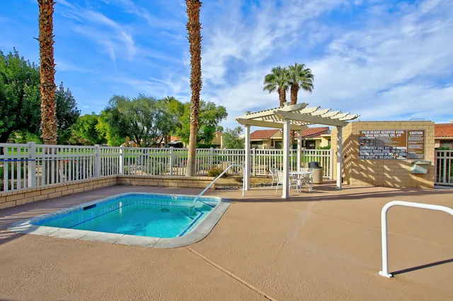 a view of a swimming pool with a chair and tables