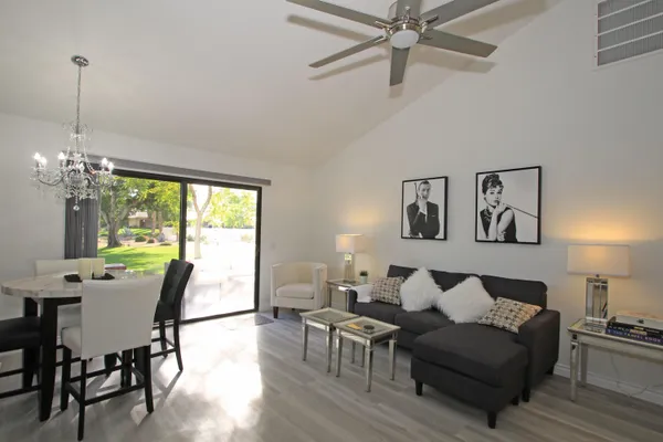 a living room with furniture a window and a chandelier