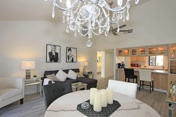 a living room with furniture or chandelier and a wooden floor