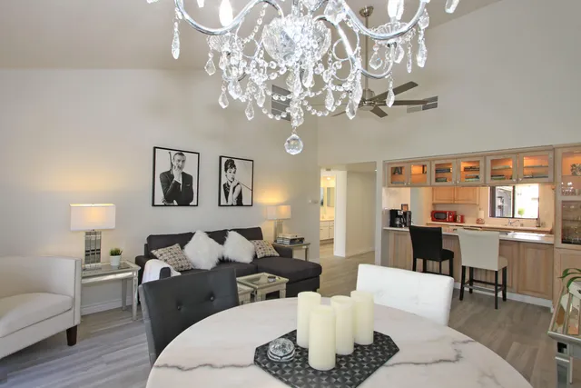 a living room with furniture or chandelier and a wooden floor