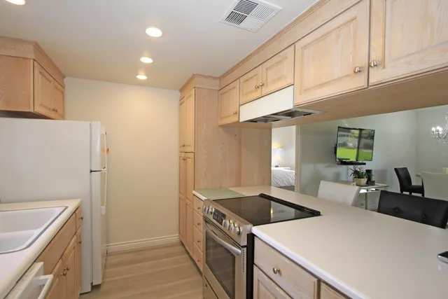 a kitchen with a stove and a refrigerator