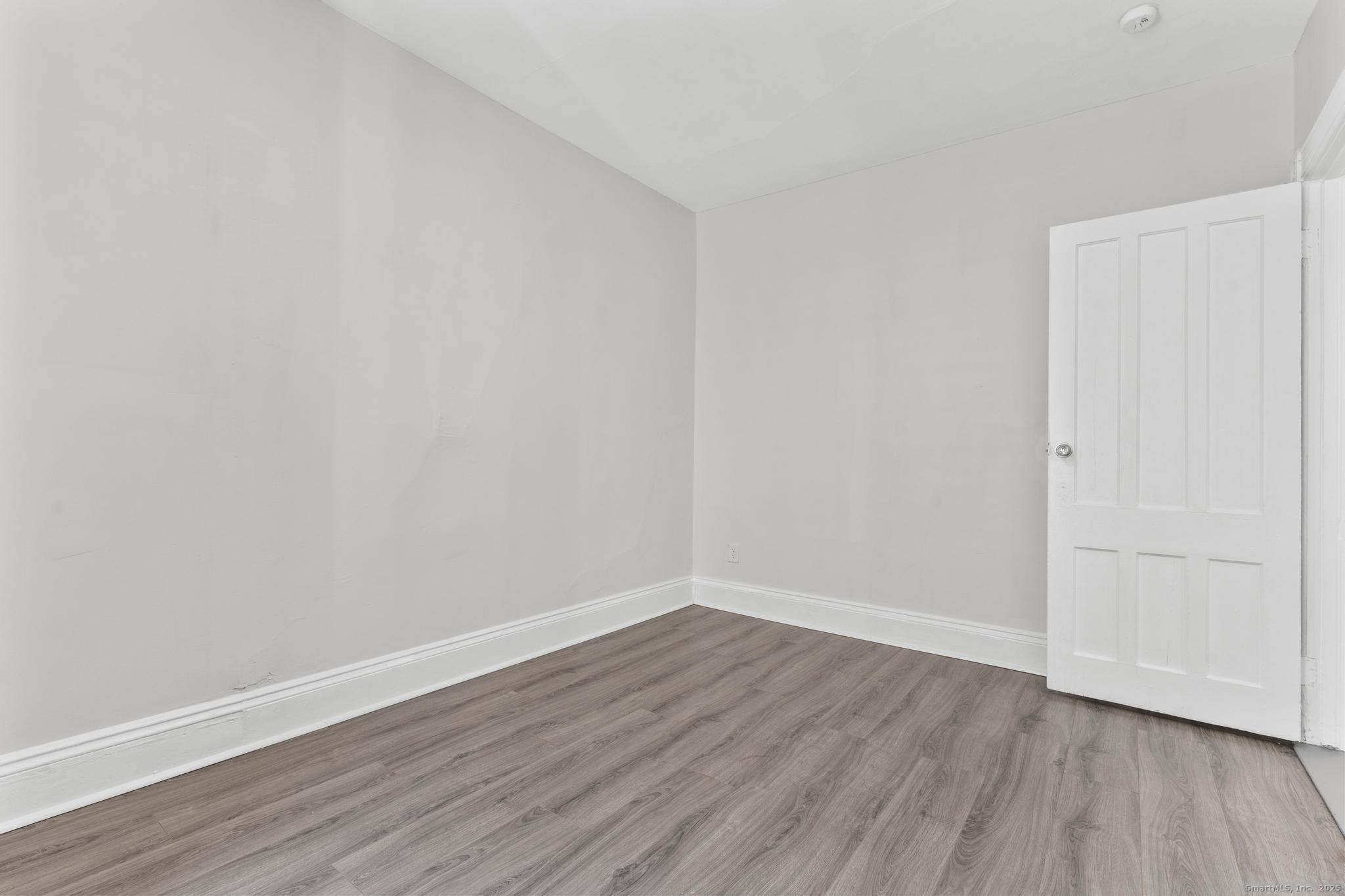 394 Gregory Street, Unit 4 Bridgeport, CT 06604 - Photo 11 of 23 a view of an empty room with wooden floor
