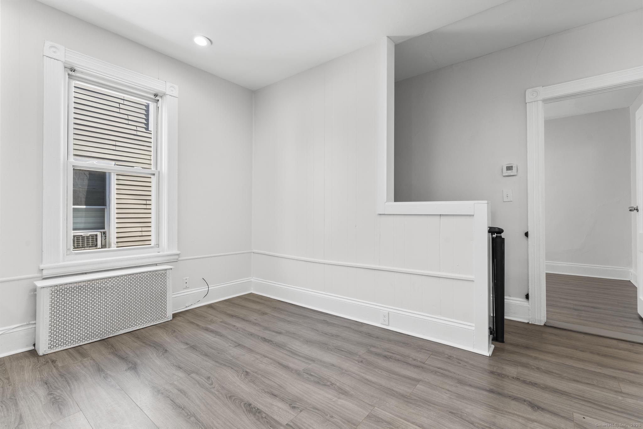 394 Gregory Street, Unit 4 Bridgeport, CT 06604 - Photo 15 of 23 an empty room with wooden floor and windows