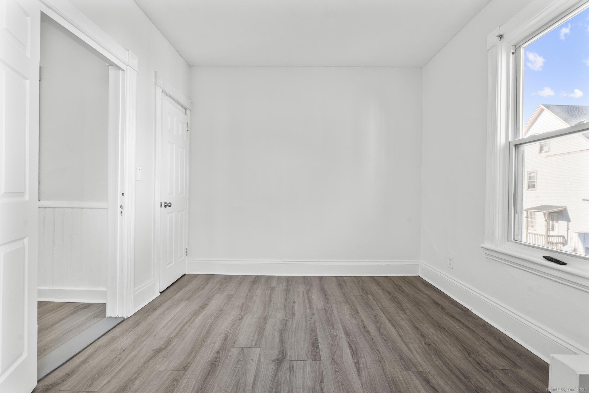 394 Gregory Street, Unit 4 Bridgeport, CT 06604 - Photo 18 of 23 a view of a room with wooden floor and brick walls