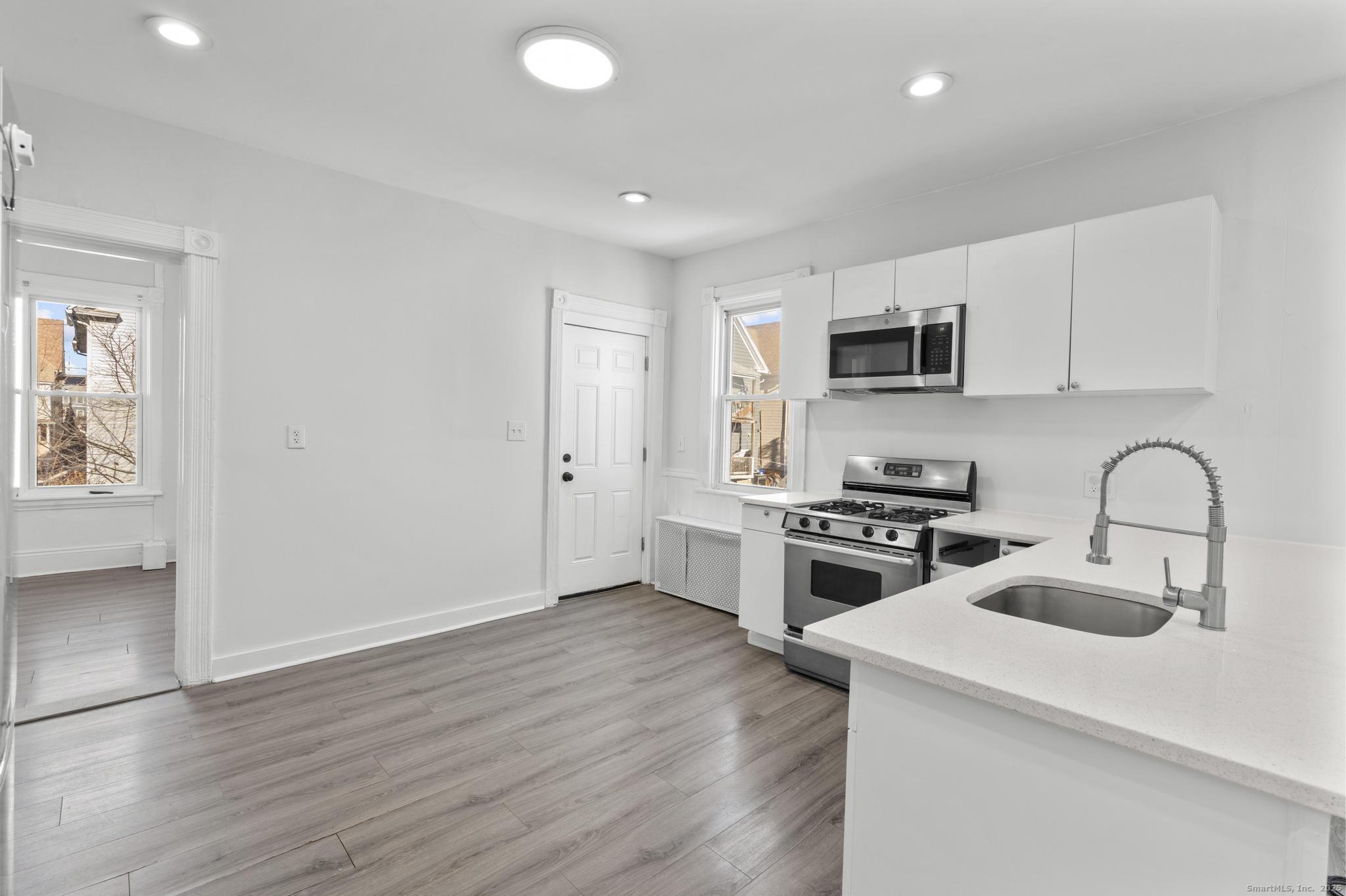 394 Gregory Street, Unit 4 Bridgeport, CT 06604 - Photo 2 of 23 a kitchen with a sink a stove and microwave