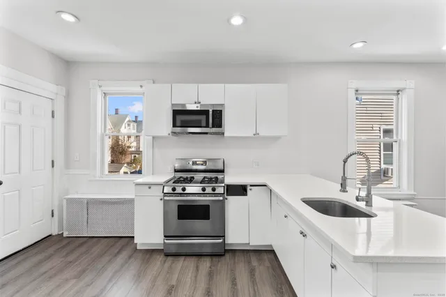 a kitchen with a stove a sink and a microwave