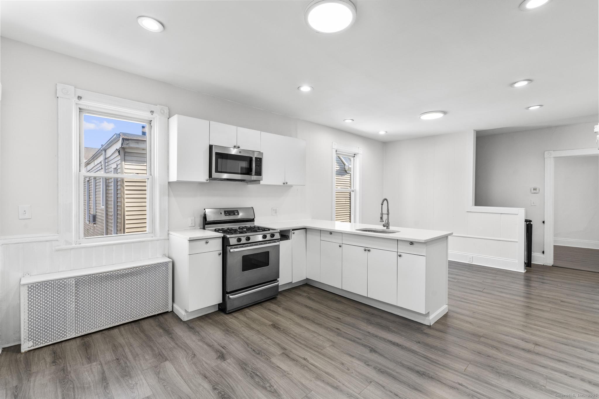 394 Gregory Street, Unit 4 Bridgeport, CT 06604 - Photo 4 of 23 a kitchen with sink a microwave and stove
