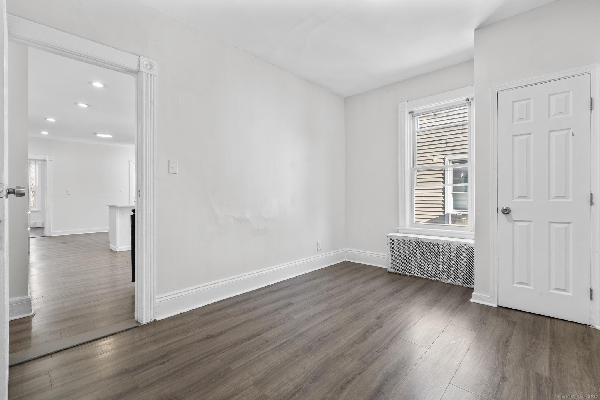 394 Gregory Street, Unit 4 Bridgeport, CT 06604 - Photo 10 of 23 wooden floor in an empty room with a window