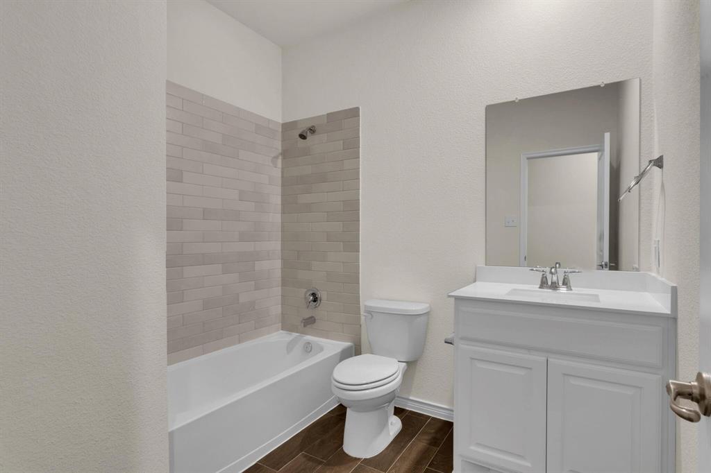 3106 Maverick Drive Forney, TX 75126 - Photo 14 of 32 a bathroom with a sink a toilet and shower