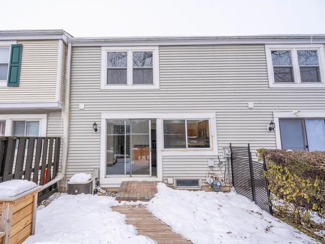 a view of a house with a patio and a yard
