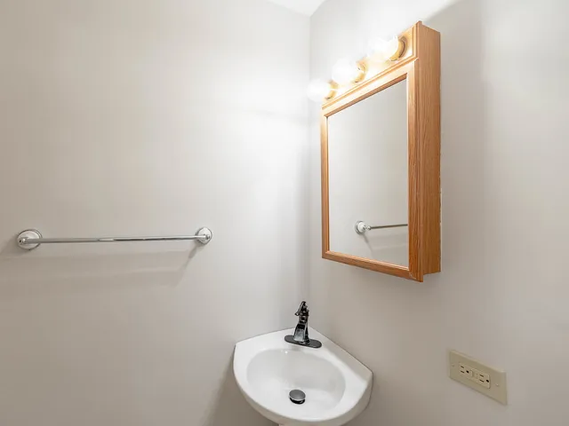 a bathroom with a sink and mirror