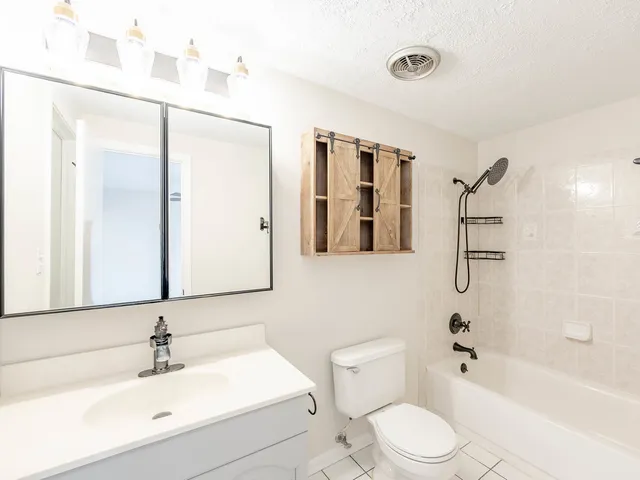a bathroom with a toilet sink and shower
