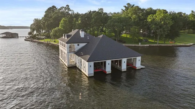 a view of swimming pool with outdoor seating and lake view