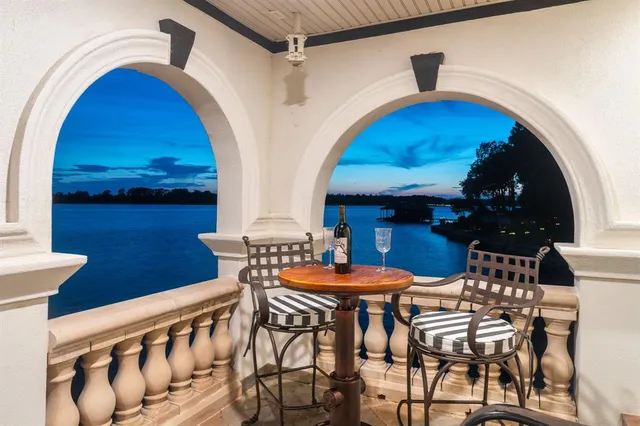 a view of a house with a patio and a car parked