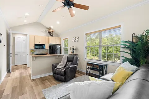 a view of a lake with a floor to ceiling window and wooden floor