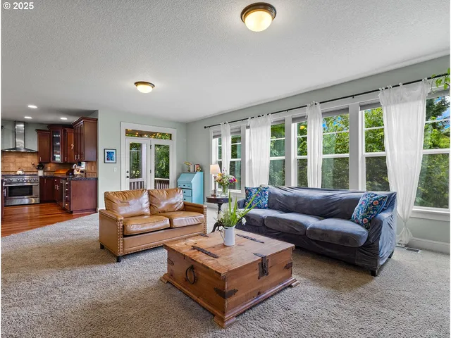 a living room with furniture a ceiling fan and a window