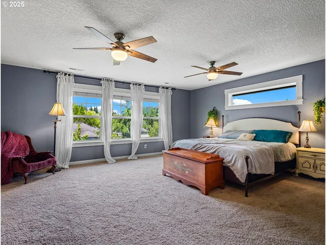 a bed room with a bed and a chair