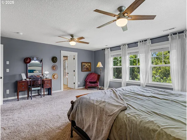 a spacious bathroom with a granite countertop sink a mirror and a shower