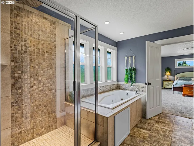 a bathroom with a bathtub and shower