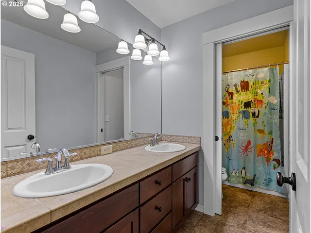 a bedroom with a bed a large window and furniture