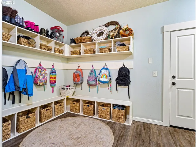 a living room with a bed and cabinets
