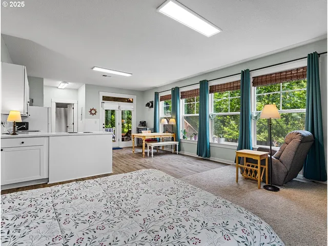 a kitchen with a sink a stove a refrigerator and white cabinets